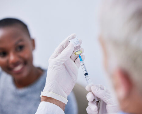 doctor holding an injection