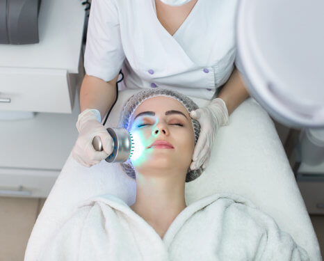 woman closing her eyes while having a face spa