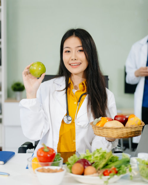 woman holding a green apple smiling