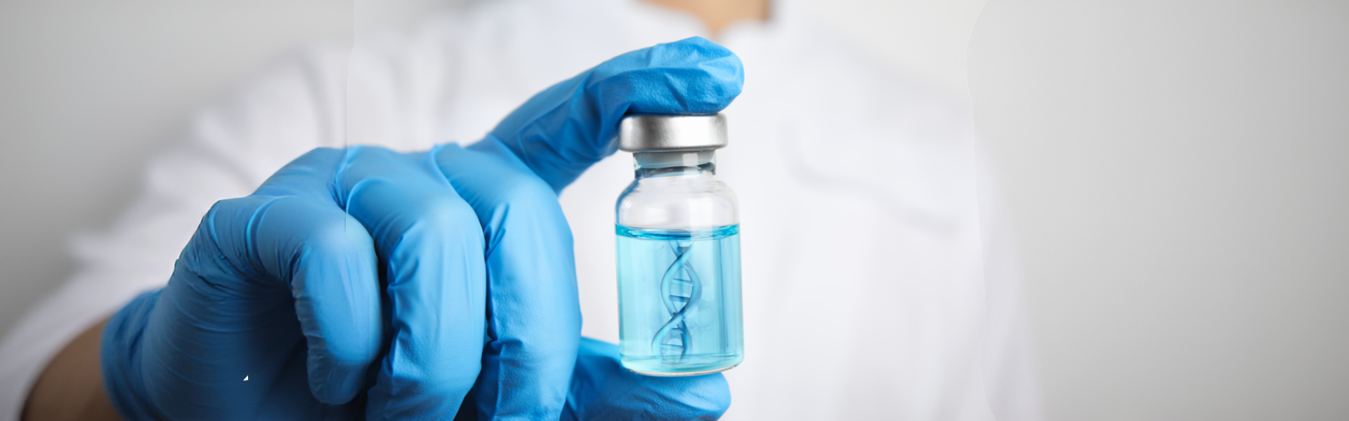 Gloved hand holds a small vial containing blue liquid and a visible DNA double helix structure inside.