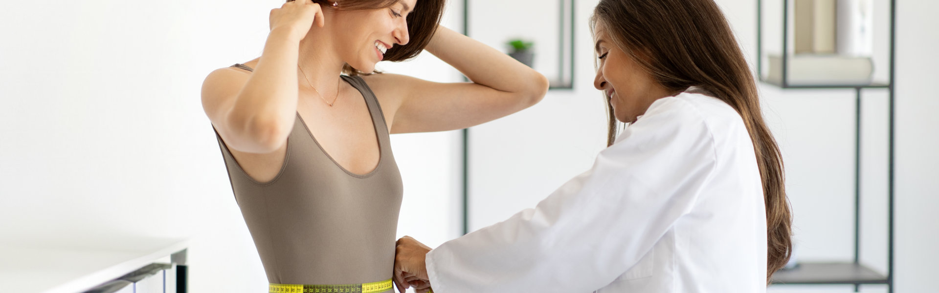 Woman Getting Measured by Doctor with Tape Measure