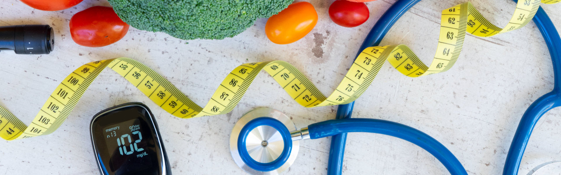 top view of vegetables, measuring tape and stethoscope