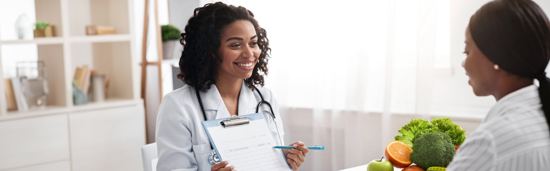 woman dietologist showing patient medical chart